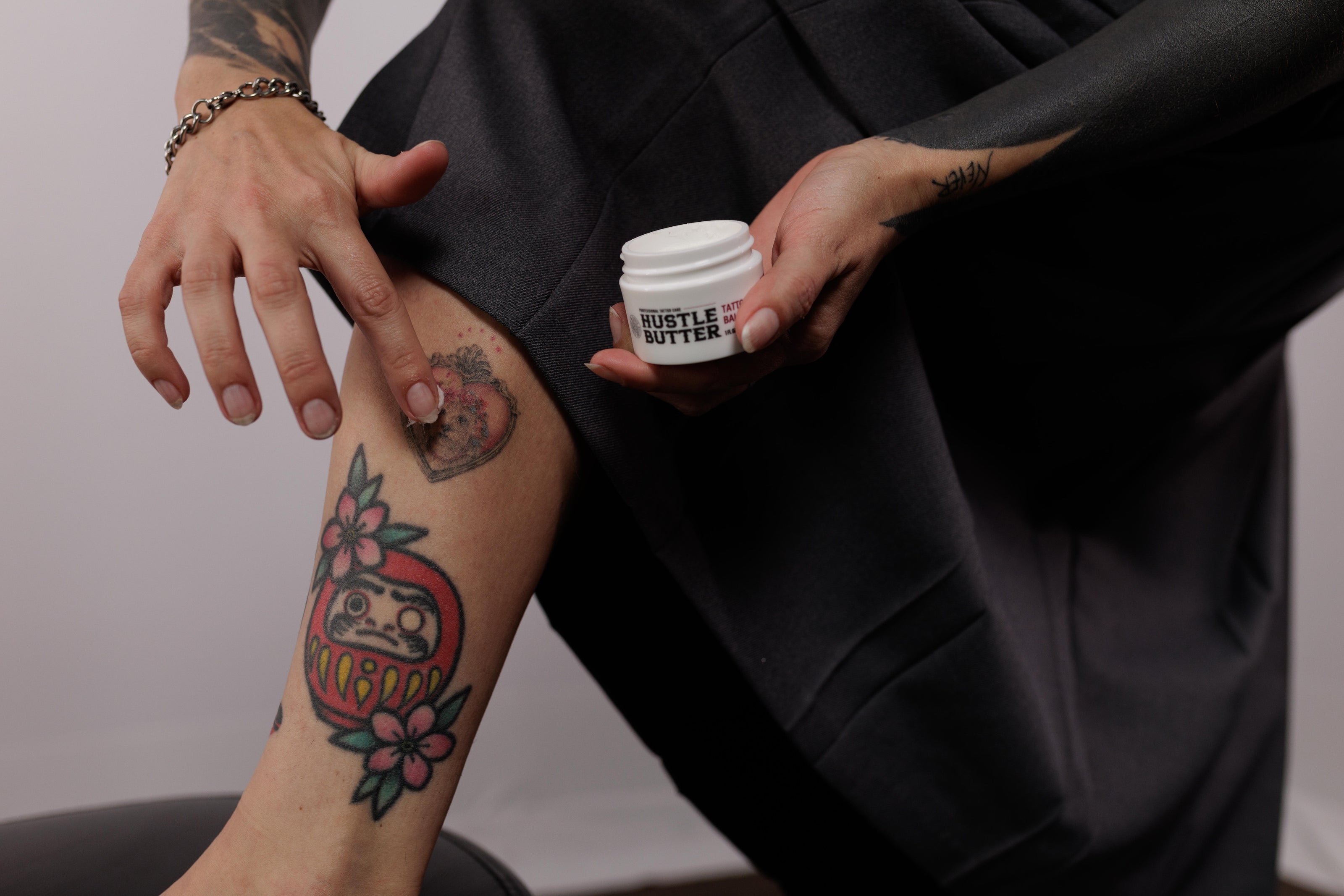 Tattoo collector holding Hustle Butter