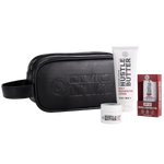 A Hustle Brand kit on a white background, including a black zippered pouch with embossed branding, a white tube of Daily Rejuvenating Lotion, a small white jar of Tattoo Balm, and a red box of SPF 50 Mineral Sunscreen Stick.