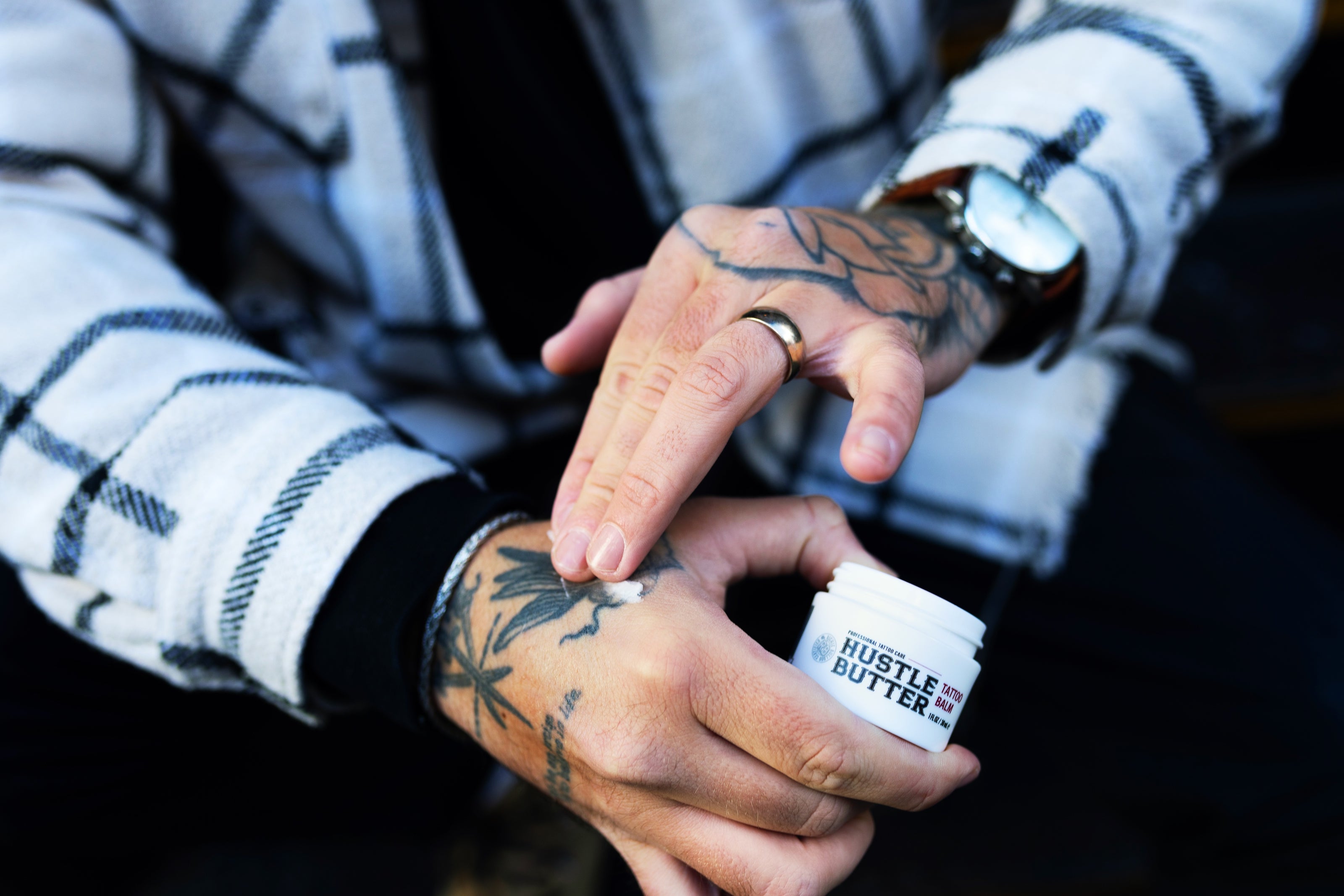 Tattoo artist applying Hustle Butter
